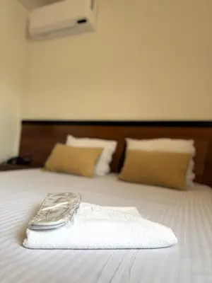 a white towel sitting on top of a bed at Hotel Petar in Kotor-Varoš