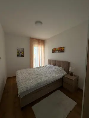 a bedroom with a bed and a window at Lux Apartman Banjaluka in Banja Luka