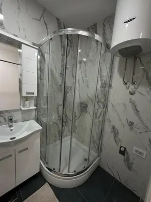 a bathroom with a shower and a sink at Lux Apartman Banjaluka in Banja Luka