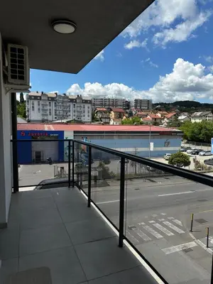 a balcony with a view of a street and buildings at Lux Apartman Banjaluka in Banja Luka