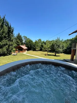a hot tub in a backyard with a view of a yard at Rancbl in Banja Luka