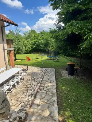 a stone path with a picnic table and a playground at Rancbl in Banja Luka