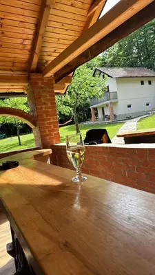 a wine glass sitting on top of a wooden table at Rancbl in Banja Luka