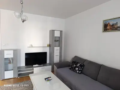 a living room with a couch and a tv at Apartman Phoenix in Banja Luka