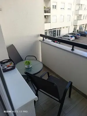 a balcony with a table and a table and a chair at Apartman Phoenix in Banja Luka