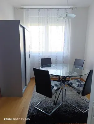 a dining room with a glass table and chairs at Apartman Phoenix in Banja Luka