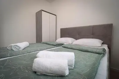 two beds with towels on them in a room at Kuća za odmor Ana in Prozor
