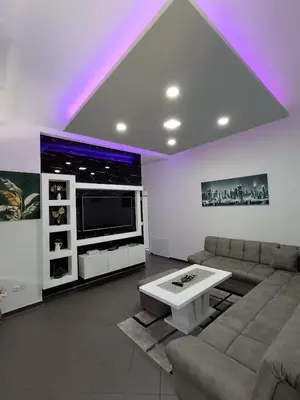 a living room with a couch and a tv at Una Festa Apartment in Bihać