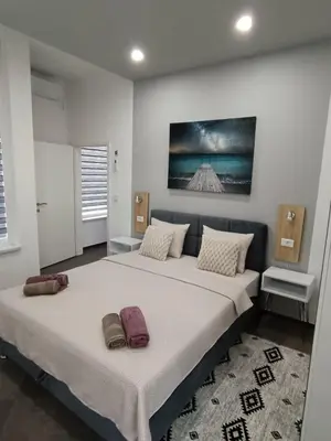 a large bed in a bedroom with two pillows on it at Una Festa Apartment in Bihać