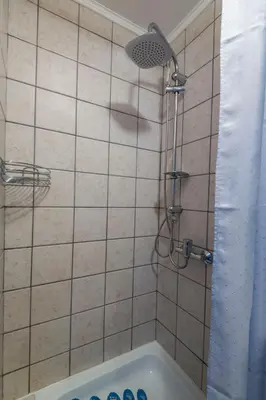 a bathroom with a shower and a bath tub at Apartment Anastasija in Doboj