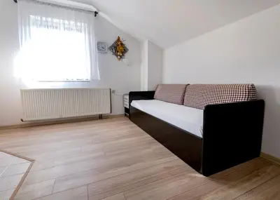 a small bedroom with a bed and a window at Apartment Anastasija in Doboj