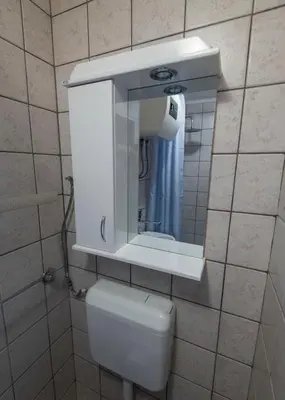 a white toilet in a bathroom with a mirror at Apartment Anastasija in Doboj