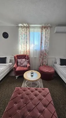 a living room with a red couch and a table at Apartments Una Roots in Orašac