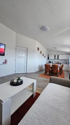 a living room with a white couch and a table at Apartments Una Roots in Orašac