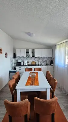 a kitchen with a white table and chairs at Apartments Una Roots in Orašac