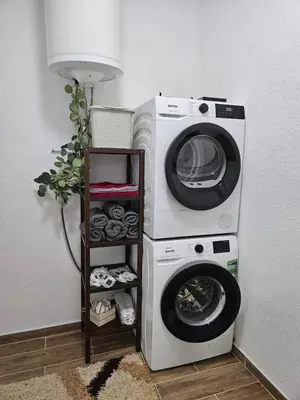 a washing machine sitting next to a lamp at Apartments Una Roots in Orašac