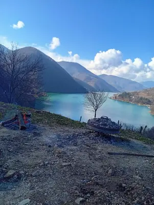 a view of a lake with a boat on the shore at Cottage Arinda in Jajce