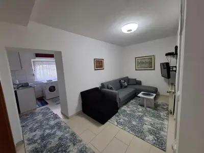 a living room with a couch and a table at Apartman Mint in Bihać