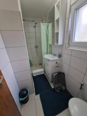 a small bathroom with a shower and a sink at Apartman Mint in Bihać