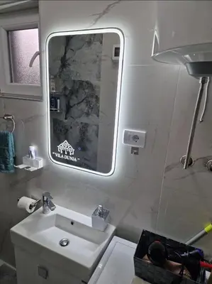 a bathroom with a sink and a mirror at Villa Dunja Prijedor in Prijedor