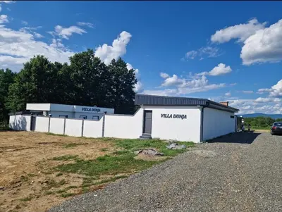 a building with a sign on the side of it at Villa Dunja Prijedor in Prijedor