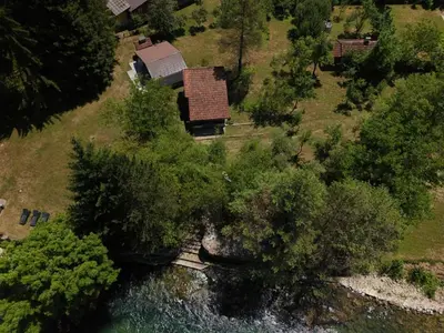 an aerial view of a house next to a river at River Nest in Kulen Vakuf