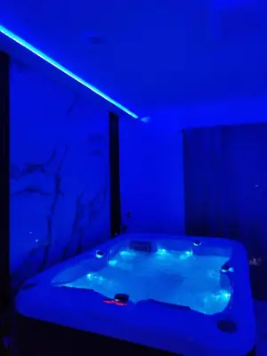 a blue room with a bath tub with a blue light at Om relax in Prijedor
