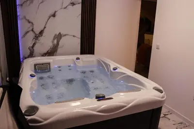 a jacuzzi tub in the corner of a bathroom at Om relax in Prijedor