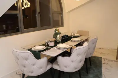 a dining room table with white chairs and a table and chairsktop at Om relax in Prijedor