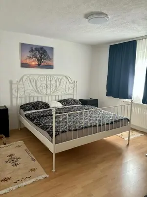 a bedroom with a white bed in a room at Apartman UnaTesnim in Bihać