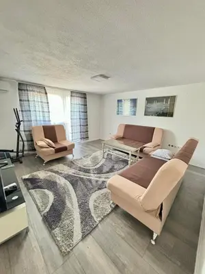 a living room with a couch and a table at Apartman UnaTesnim in Bihać