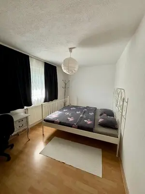a bedroom with a bed and a desk in a room at Apartman UnaTesnim in Bihać
