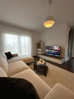 a living room with two couches and a flat screen tv at Apartment Alma in Bihać