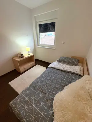 a bedroom with two beds and a window at Apartment Alma in Bihać
