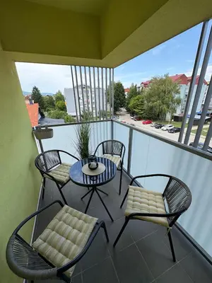 a balcony with a table and chairs and a view at Apartment Alma in Bihać