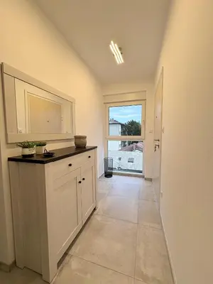 a kitchen with a counter and a large window at Apartment Alma in Bihać