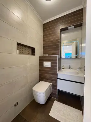 a bathroom with a toilet and a sink and a mirror at Apartment Alma in Bihać