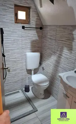 a small bathroom with a toilet and a sink at Green Una Wooden House in Kulen Vakuf