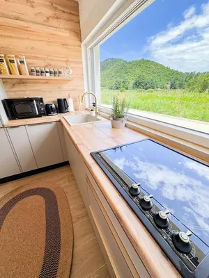 a kitchen with a counter with a sink and a window at Villa Aurelia Wellness in Illidža