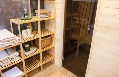 a closet with wooden shelves and towels in it at Villa Aurelia Wellness in Illidža