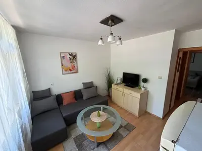 a living room with a couch and a table at Bihac Center Apartment in Bihać