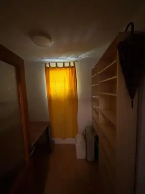 a room with a yellow curtain and a closet at Bihac Center Apartment in Bihać
