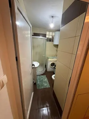a small bathroom with a toilet and a sink at Bihac Center Apartment in Bihać