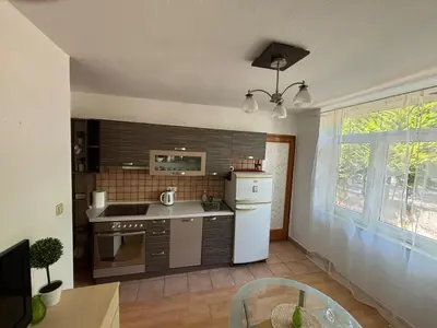 a kitchen with a white refrigerator and a stove at Bihac Center Apartment in Bihać