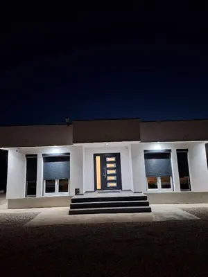 a white building with a staircase in front of it at night at Nature flow Bihac in Otoka