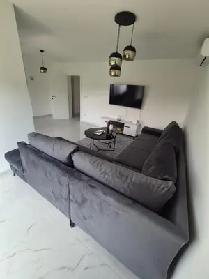 a large couch in a living room with a television at Nature flow Bihac in Otoka
