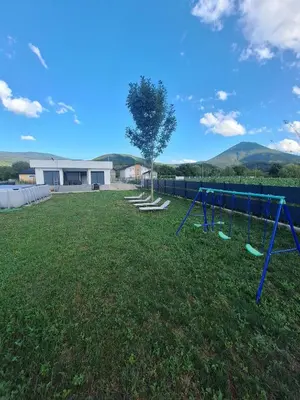 a playground in a yard with a building at Nature flow Bihac in Otoka
