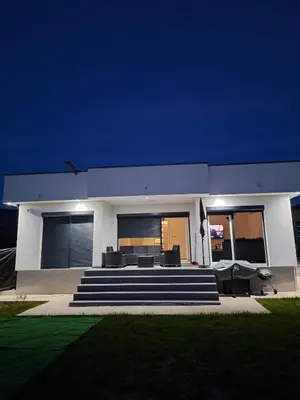 a white house with a couch and some stairs at Nature flow Bihac in Otoka