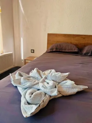 a towel sitting on top of a bed at Apartman Alinac in Cazin
