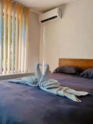 two swans made out of towels on a bed at Apartman Alinac in Cazin